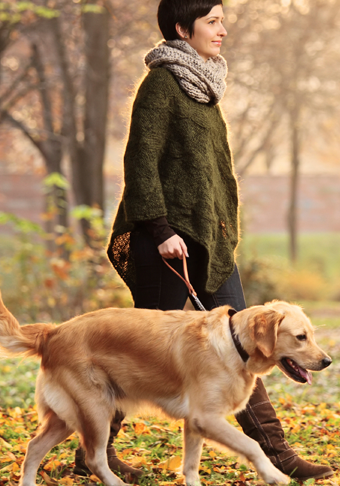 A woman walking her dog in the park.